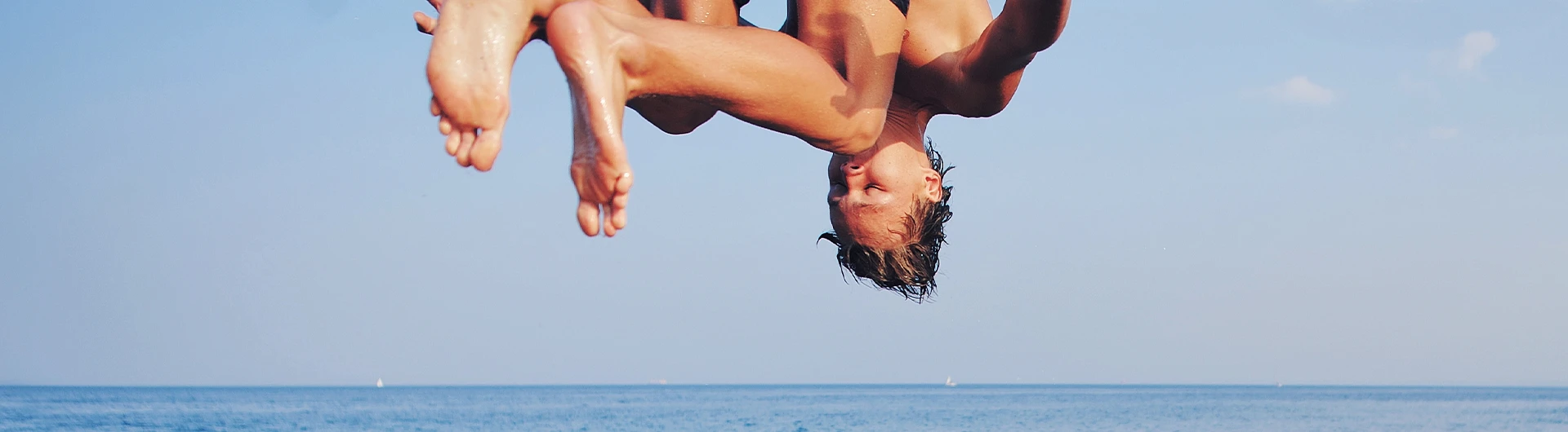 A person jumping into the sea (photo)