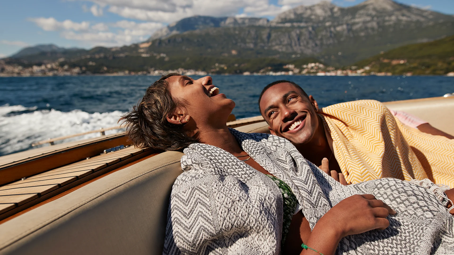 erson sitting in a boat laughing (photo)