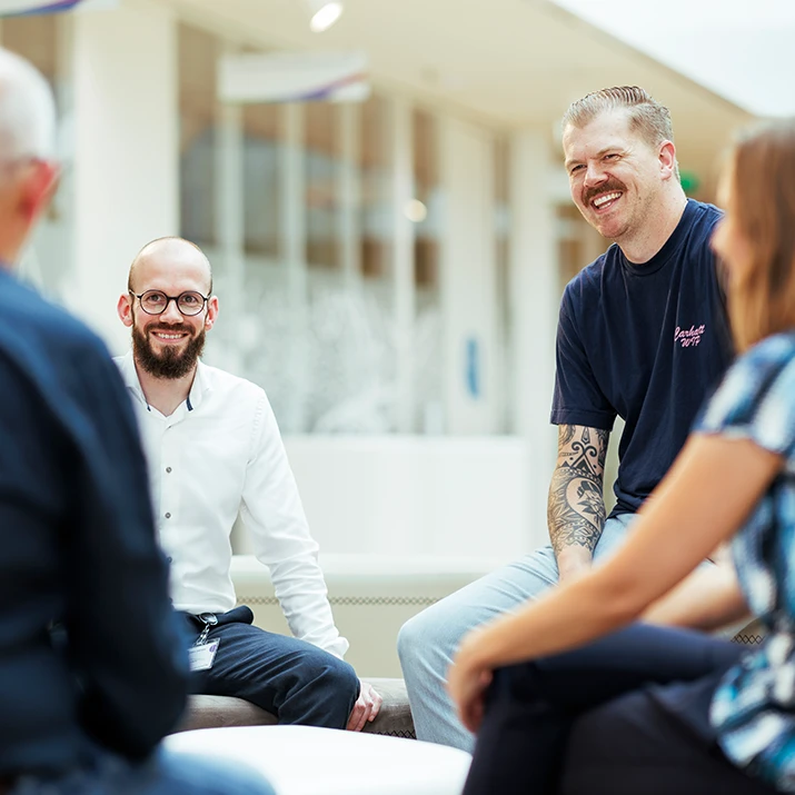 Colleagues sitting together and talking in a bright office. (photo)