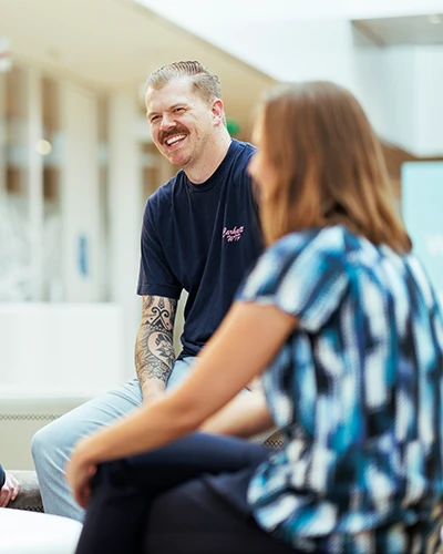 Colleagues sitting together and talking in a bright office. (photo)