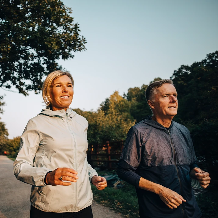 Two people jogging together in a park. (photo)